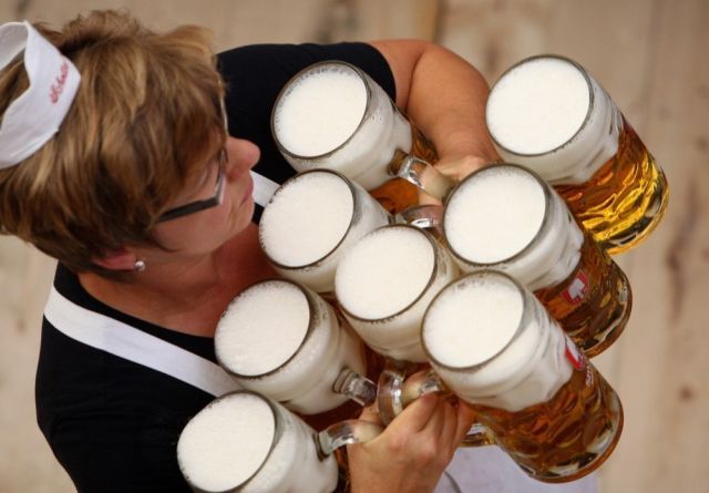 MUNICH, GERMANY - SEPTEMBER 19:  A waitress carries beer mugs at the Schottenhamel beer tent on September 19, 2009 in Munich, Germany. Oktoberfest is Germany's and the world largest fair. About six million people attend the sixteen-day festival during late September and early October.  (Photo by Miguel Villagran/Getty Images)